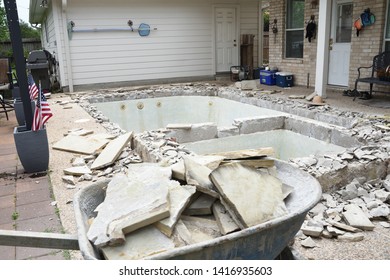 Swimming Pool Being Demolished With Jack Hammer For Remodel And New Tile And Coping And Plaster With Wheelbarrow