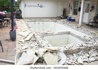 Swimming Pool Being Demolished With Jack Hammer For Remodel And New Tile And Coping And Plaster With Wheelbarrow