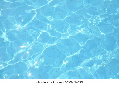 Swimming Pool Bottom Caustics Ripple And Flow With Waves Background. Summer Background. Texture Of Water Surface. Overhead View.