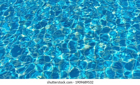 Swimming Pool Bottom Caustics Ripple And With Waves Background. Summer Background. Texture Of Water Surface. Overhead View.