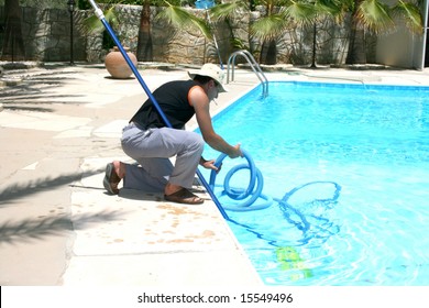 Swimming Pool Cleaner During His Work.