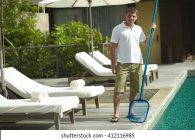 Swimming Pool Cleaner During His Work At Tropical Villa. Professional Cleaning Service At Work. Private Property Service.