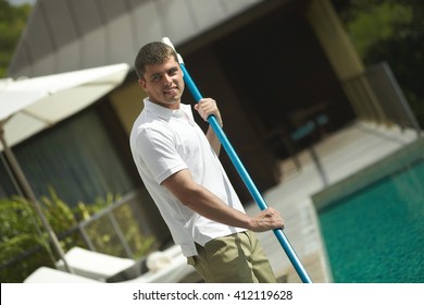 Swimming Pool Cleaner During His Work At Tropical Villa. Professional Cleaning Service At Work. Private Property Service.