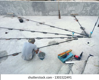 Swimming Pool Construction.The Technician Is Installing A Vertical Line To The Level Of The Slope Of The Swimming Pool Floor.	
