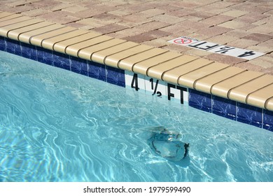 Swimming pool and edge showing the depth of the water.