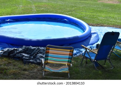 Swimming Pool And Lawn Chairs In A Yard