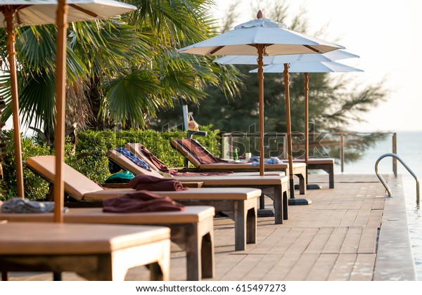 pool lounge chairs with umbrellas