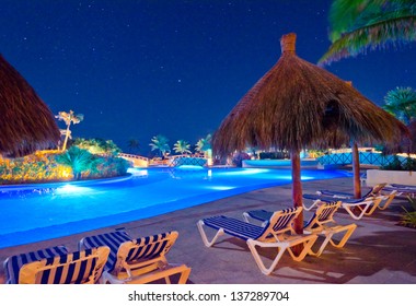 Swimming Pool At A Luxury Caribbean Resort At Night, Dawn Time. Bahia Principe, Mexican Resort.