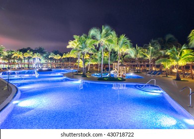 Swimming Pool At A Luxury Caribbean, Tropical Resort At Night, Dawn Time.