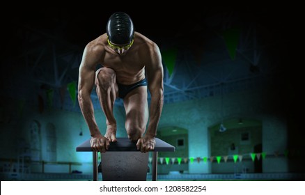 Swimming pool. Muscular swimmer ready to jump.