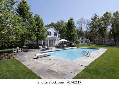 Swimming Pool Outside Luxury Home With Diving Board