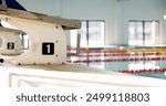 Swimming pool, sports and podium with number in gym for practice, training and exercise for event. Water, aquatic center and diving board for international race, challenge and competition for fitness