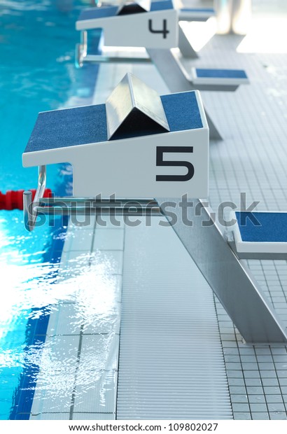 Swimming pool with starting\
blocks