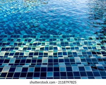 Swimming Pool Steps With Clear Water Surface Background, Nobody. Abstract Pool Texture, Underwater Pattern Blue Background With Grid Tiles, No People. Overhead View. Summer Background.