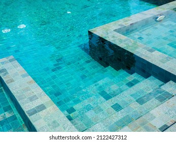 Swimming pool steps with clear water surface background, nobody. Abstract pool texture, underwater pattern blue background with grid tiles, no people. Overhead view. Summer background. - Shutterstock ID 2122427312