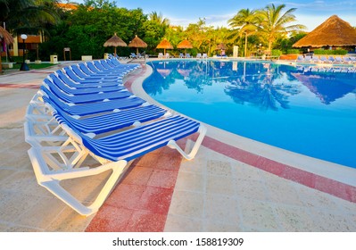 Swimming Pool Surrounded By Chairs At The Luxury Mexican Resort. Bahia Principe, Riviera Maya.