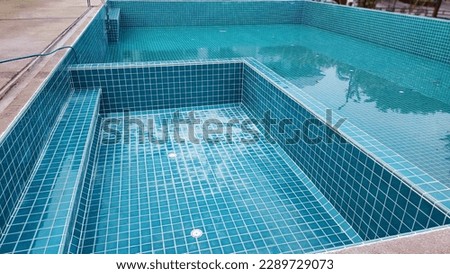 The swimming pool is under tiling maintenance