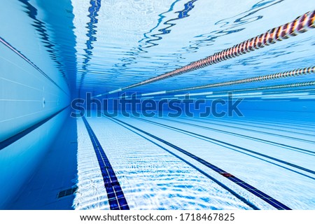 Swimming pool underwater blue background.