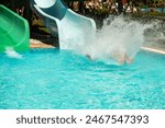 Swimming pool with water slides, water slide ride, lots of splashes