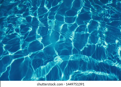 Swimming pool water sun reflection background. Ripple Water.