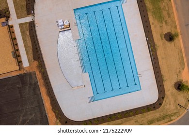 A swimming pool is with water used for swimming other water activities in near apartment - Shutterstock ID 2175222909
