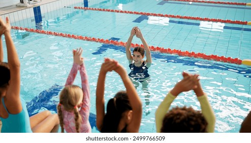 Swimming pool, woman and children with fitness, water and coach with safety, instructions and teaching. People, trainer and students with recreation, learning and instructor with conversation or kids - Powered by Shutterstock