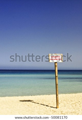 Similar – two straw beach umbrellas on an empty seashore on a clear day