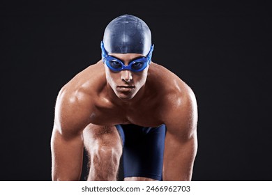 Swimming, ready and portrait of man in studio with sports for competition, marathon or cardio exercise. Athlete, fitness and swimmer with pose for dive, start or training on black background - Powered by Shutterstock