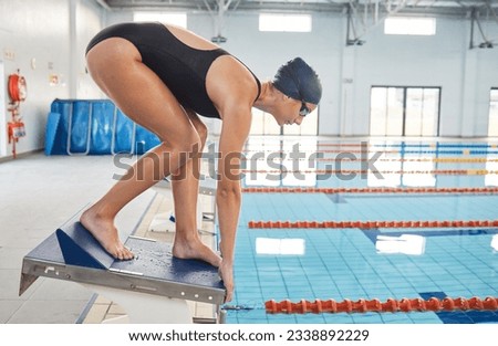 Swimming, sports and woman jump in pool for exercise, training and workout for competition in gym. Fitness, diving and female swimmer on starting block for water sport race, challenge and performance