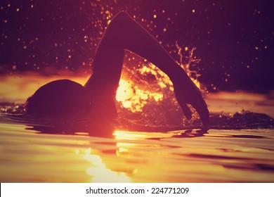 Swimming in sunset/sunrise. - Powered by Shutterstock