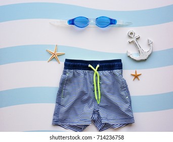 Swimming Trunks Of Boy And Goggles On Color Background