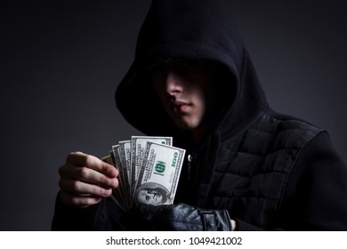 The Swindler In The Hood Counts The Stolen Money