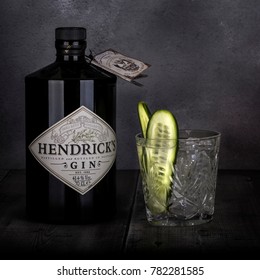 SWINDON, UK - DECEMBER 27, 2017: 70 cl bottle of Hendricks distilled gin with a glass and Cucumber on a Dark Rustic background