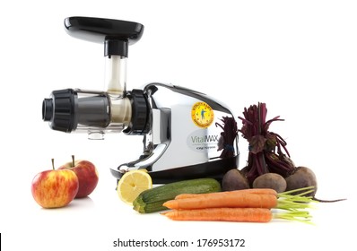 SWINDON, UK - FEBRUARY 16, 2014: Vital Max Juice Machine With Fruits And Vegtables On A White  Background