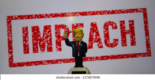 Swindon, Wiltshire, UK, Sept 2018. Trump Bobble Head Figure With A Screw In Hand On White Background With The Word Impeach In Red.