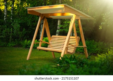 Swing for the garden made of wood. Garden furniture with your own hands. Relax in the garden of your own house.Country holidays.