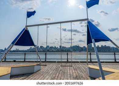 A Swing In The Jean-Drapeau Park Maritime Shuttle Landing Stage. Saint Helens Island In Sunset Time. Montreal, Quebec, Canada.