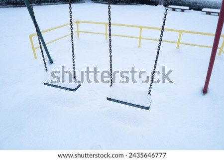 Swing seat covered with snow