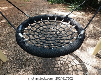 Swing Or Seat With Webbing At Playground And Wood Chips