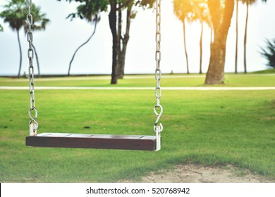 swing,Empty swing placed in the garden with flare light