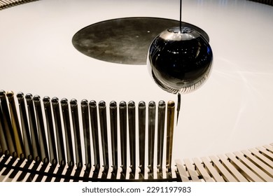 Swinging ball of the Eddy pendulum in a science demonstration. - Powered by Shutterstock