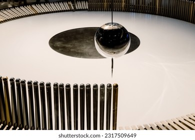 Swinging ball of the Eddy pendulum in a science demonstration. - Powered by Shutterstock