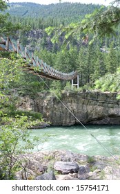 Swinging bridge over a mountain river