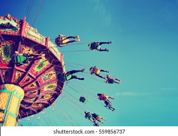  a swinging fair ride at dusk toned with a retro vintage instagram filter  - Shutterstock ID 559856737