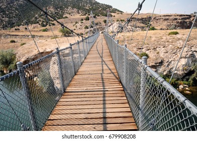 Swinging historic iron suspension bridge at Hot Springs State Park, Thermopolis, Wyoming, crosses Big Horn River.