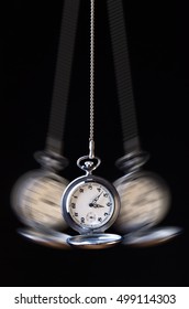 Swinging Pocket Watch Hypnosis On A Black Background