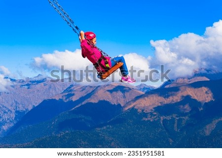 Swings above the clouds attraction at Rose or Rosa Peak mountain station in Sochi resort region in Krasnodar Krai, Russia