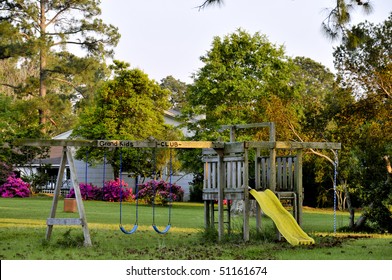 A Swingset In The Back Of A Yard