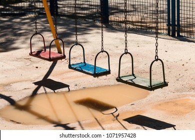 Swingset over a puddle on a playground
