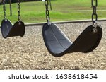 A swingset in a sunny park